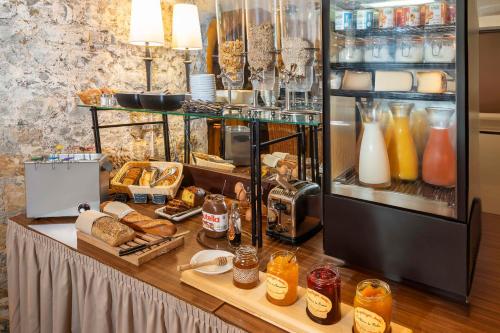a buffet with bread and drinks and a refrigerator at Best Western de Diane in Nevers