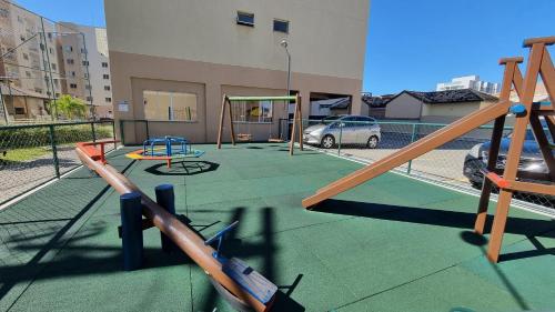 a playground with play equipment on a building at Egidios AP - Centro de São Pedro da Aldeia in São Pedro da Aldeia
