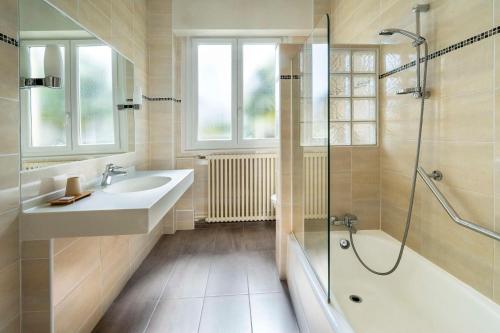 a bathroom with a sink and a shower at Best Western de Diane in Nevers