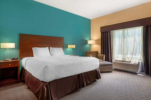 a hotel room with a large bed and a window at Best Western Plus French Lick in French Lick