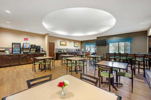 a restaurant with tables and chairs and a bar at Best Western Plus French Lick in French Lick