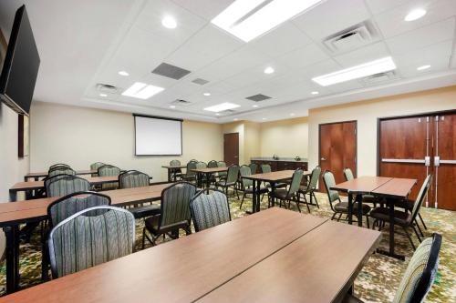a conference room with tables and chairs and a screen at Best Western Plus French Lick in French Lick