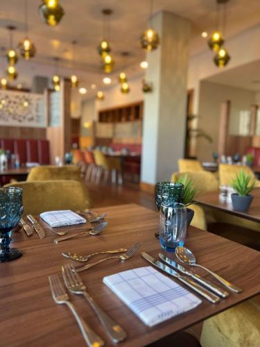 a wooden table with silver utensils on top of it at Radisson Blu Hotel, Durham in Durham