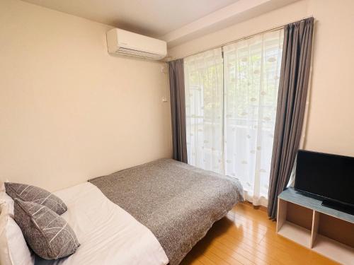 Postel nebo postele na pokoji v ubytování シャンテ高田馬場32