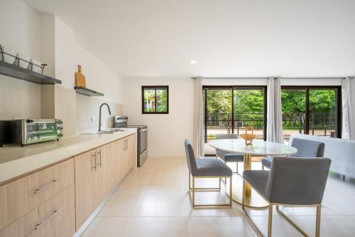 a kitchen with a table and chairs and a dining room at The Shovel in Playa Avellana