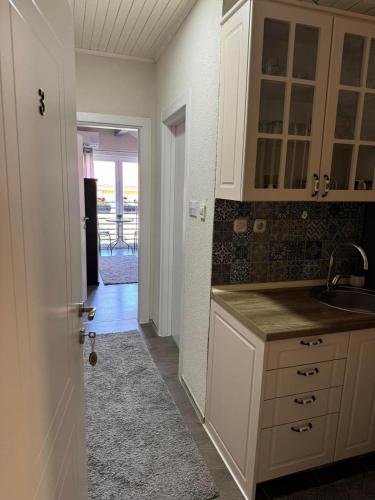 a kitchen with white cabinets and a sink at Villa Ristovski in Ohrid
