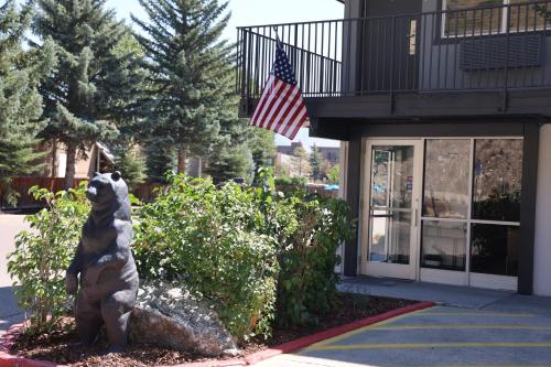 a bear statue in front of a building with an american flag at The Jackson SouthTown in Jackson