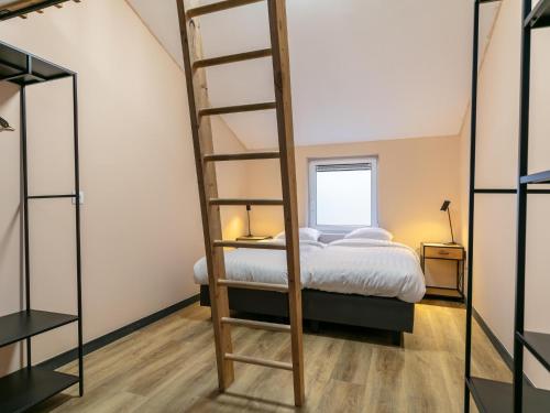 a bedroom with a bunk bed and a ladder at Ons Huis in Rodenboom