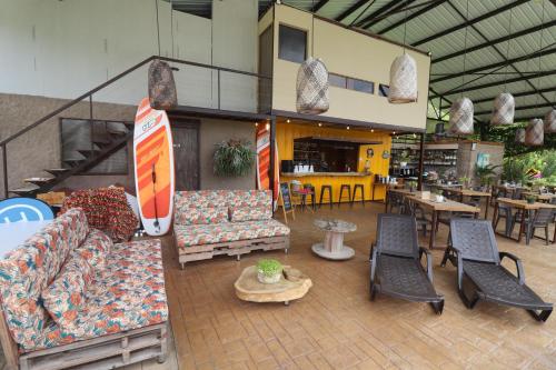 a living room with couches and chairs and tables at Adama Biohotel in Calima
