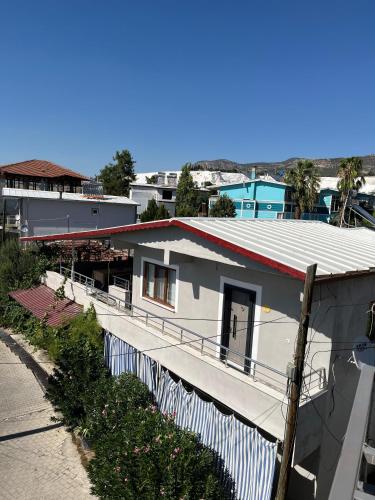 a white house with a fence next to a street at Gökçen Home in Pamukkale
