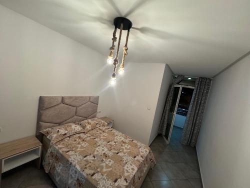 a bedroom with a bed and a ceiling with a chandelier at MTL residence in Oujda