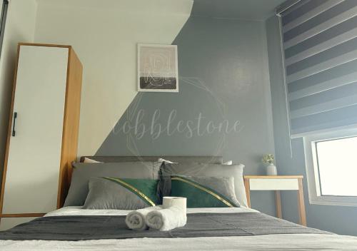 a bedroom with a bed with towels on it at SM Mezza 1 Residences in Manila