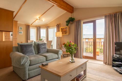 a living room with a couch and a table at 5 Ocean View in Woolacombe
