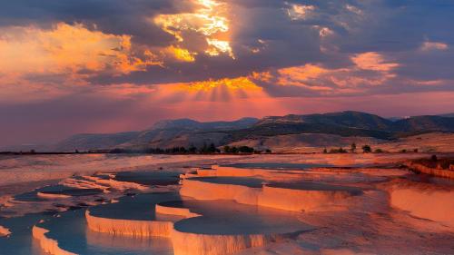 a sunset over a river in the desert at Gökçen Home in Pamukkale