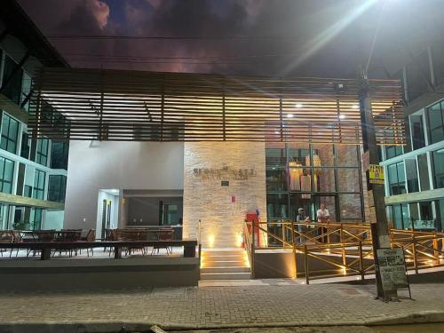 a building with a staircase in a city at night at Flat térreo com piscina privativa in Porto De Galinhas