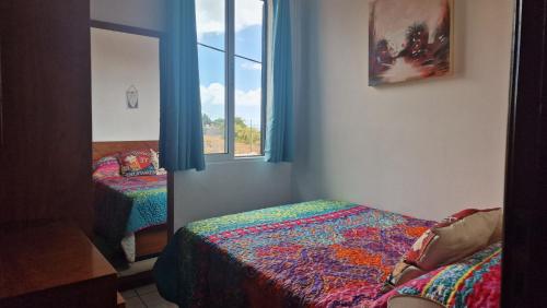 a room with two beds and a window at Jose's cozy little home in Funchal