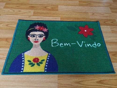 a painting of a woman on a green rug at Casa 24 Puerto Iguazu in Puerto Iguazú