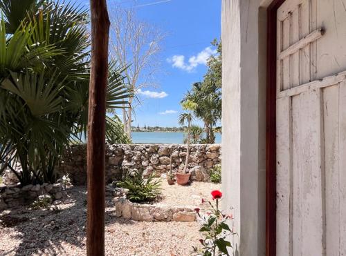 a door to a house with a view of the water at Casa Ik en Coba in Cobá