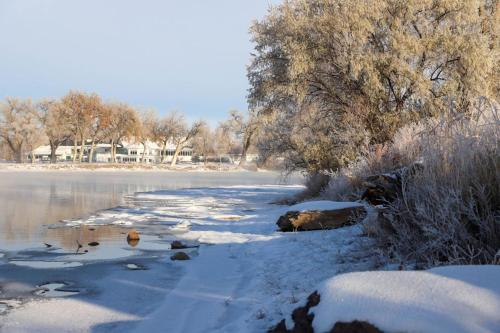 a body of water with snow and trees on it at Staybridge Suites Great Falls by IHG in Great Falls