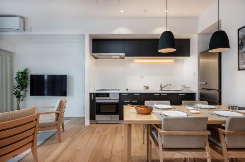 a kitchen and dining room with a table and chairs at Kaku Place by H2 Life in Furano