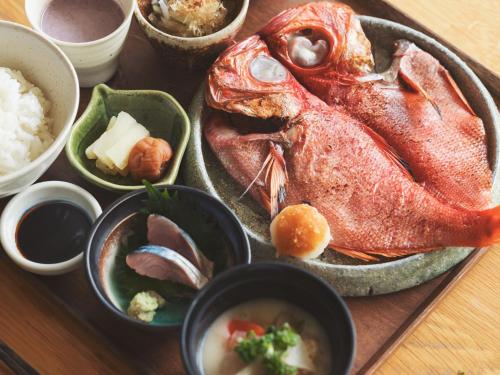 a plate of food with a fish on a table at SOKI ATAMI in Atami