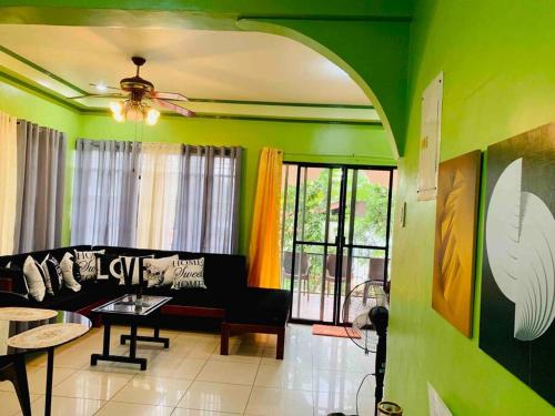 a living room with a couch and a table at EntireHouse n Panglao FastWiFi AC HotShowers Netflix in Dauis