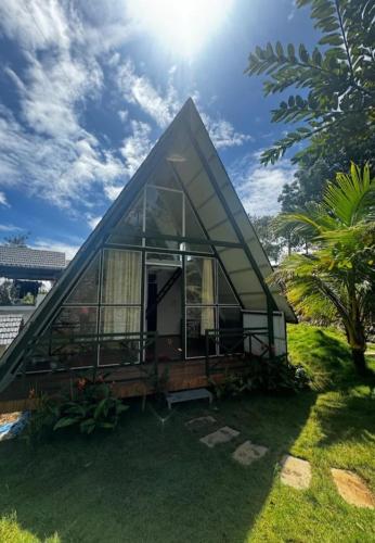 a small house with a glass facade on the grass at Royal Woods in Meppādi