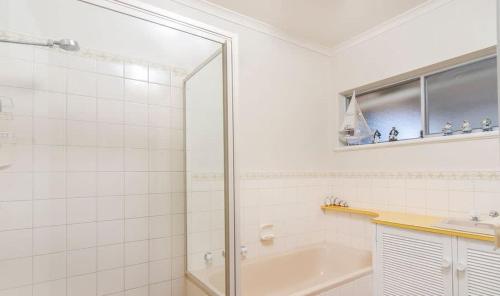 a bathroom with a shower and a sink and a tub at Ratties Residence 6 Carnegie St Port Ellliot - No Linen Included in Port Elliot