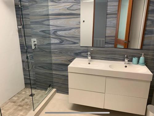 a bathroom with a sink and a mirror at Villa Brisas del Mar-Ocean View, Gated Community in Dorado