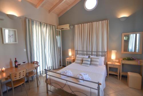 a bedroom with a bed and a table and a desk at Villa Theodora in Nikiana