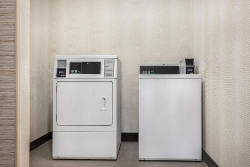 two refrigerators are sitting next to each other at Holiday Inn Cheshire - Southington by IHG in Southington