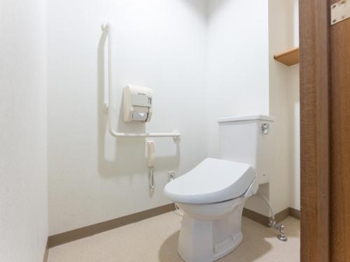 a bathroom with a white toilet in a stall at LiVEMAX Resort Upopoi Shiraoi Onsen in Shiraoi