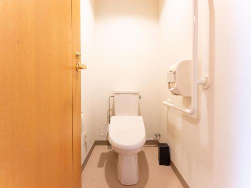 a bathroom with a white toilet in a stall at LiVEMAX Resort Upopoi Shiraoi Onsen in Shiraoi