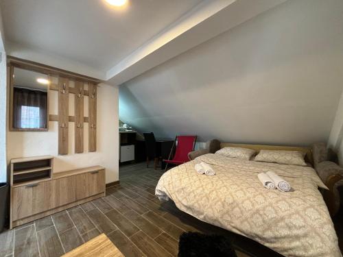 a bedroom with a bed with two towels on it at Apartment RestArt in Kolašin