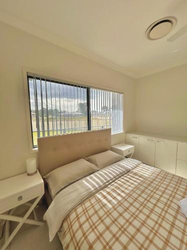 a bedroom with a bed and a large window at 7 Bedrooms 20 Mins to City 25 Acres of Green Space in Brisbane