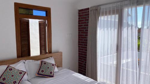 Ένα ή περισσότερα κρεβάτια σε δωμάτιο στο Griyo Antik Villa