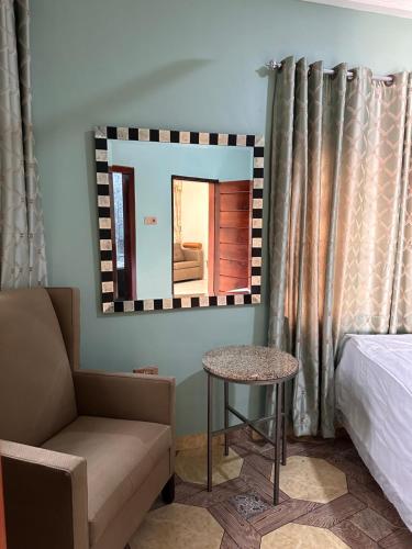 a room with a mirror and a couch and a table at Short term rental in Accra