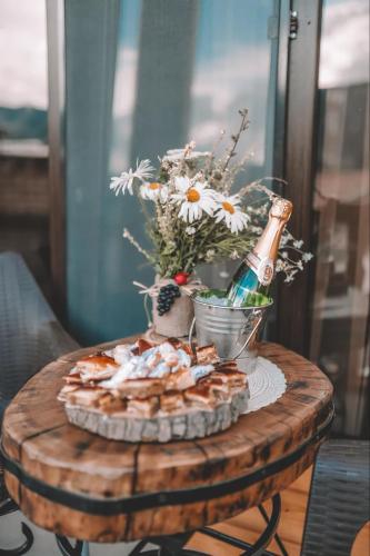 a table with a plate of food and a bottle of champagne at Eco House in Odzun