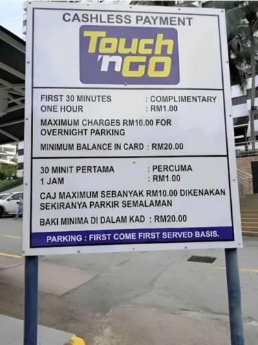 a sign for a tennis tournament on a street at Sri Sayang at Batu Feringghi Beach by Plush in Ayer Itam