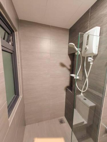 a bathroom with a shower with a glass door at Maya Bay Gamuda Cove Splash Mania near KLIA and Cyberjaya in Pulau Kempas