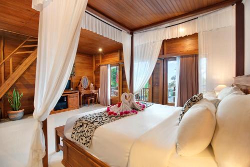 a bedroom with a large bed in a room with windows at BB Resort Villa and Spa in Nusa Penida