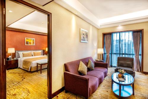 a hotel room with a bed and a mirror at Leeden Hotel Guangzhou in Guangzhou