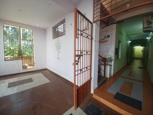 an empty room with a staircase in a house at Eco tree in Kottakupam