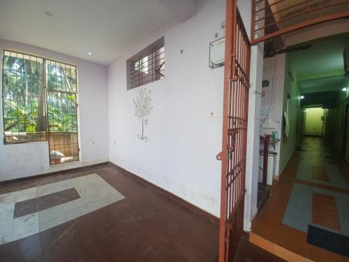 an empty room with white walls and windows at Eco tree in Kottakupam