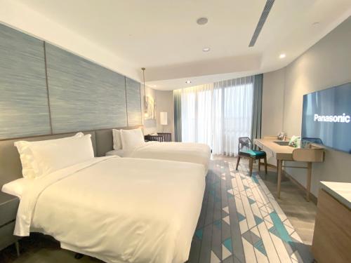 En eller flere senge i et værelse på Wyndham Sun Moon Lake