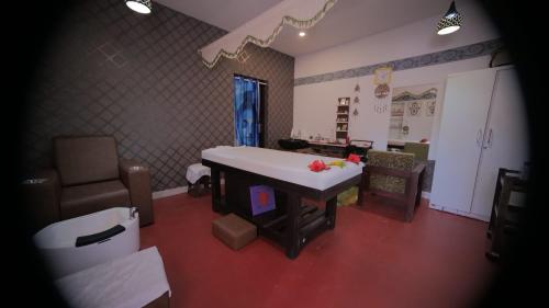 a living room with a table and a couch at Veda5 Ayurveda Living Village in Trichūr