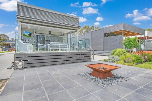 a house with a bench and a table at 56@Highview-Echuca Holiday Homes in Moama