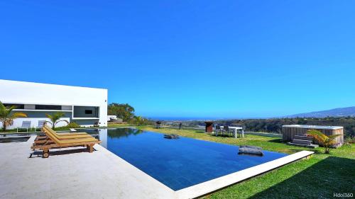a swimming pool in the backyard of a house at La Villa Phoenix in Saint-Pierre