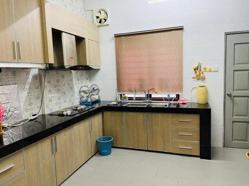 a kitchen with a sink and a counter top at Batang kali Home stay on the Hill in Batang Kali