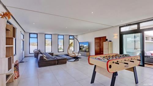 a living room with a game table in the middle at La Villa Phoenix in Saint-Pierre
